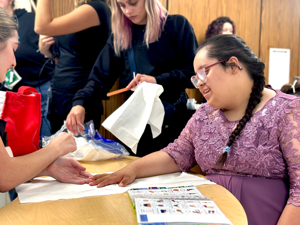 Woodland student getting her nails done by TEC students in preparation for Fash Bash