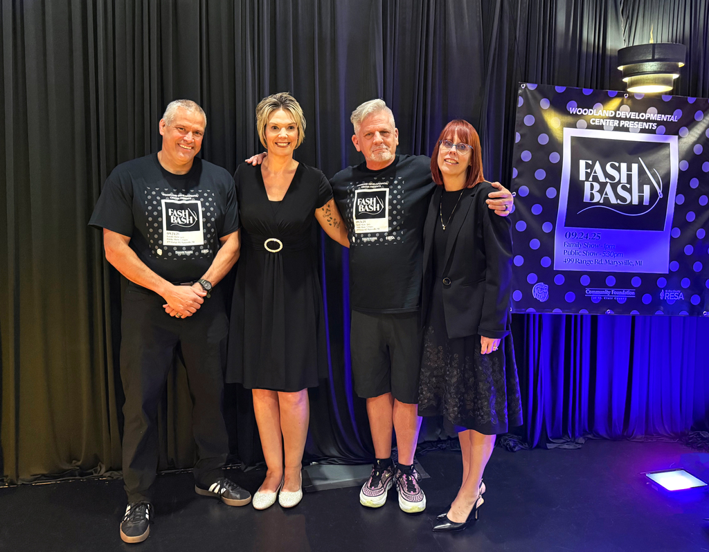 Woodland Assistant Principal Ethan Barden, Woodland Aide and Event Emcee Katie Osterland, Woodland Art & Music Teacher and event chairAlan Demski, and RESA Superintendent Brenda Tenniswood pose on stage at Fash Bash