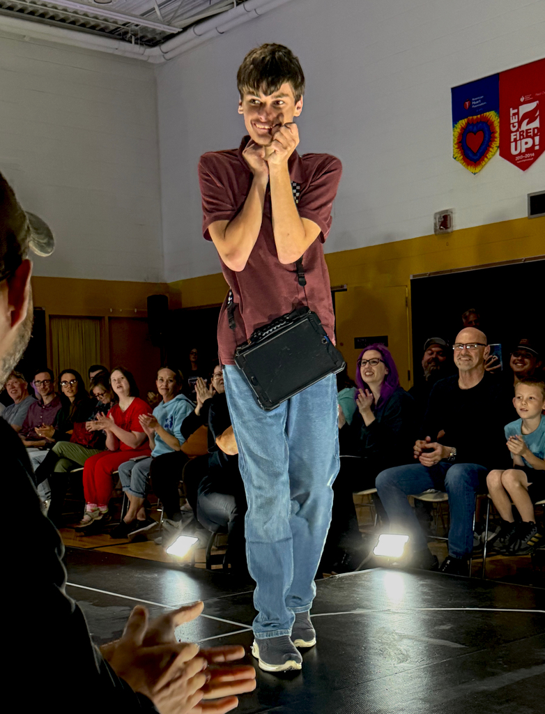 A Woodland student smiles as he walks the runway at the inaugural Fash Bash 