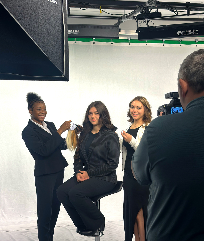 behind the scenes photo of cosmetology students posing for a picture for dress 4 success