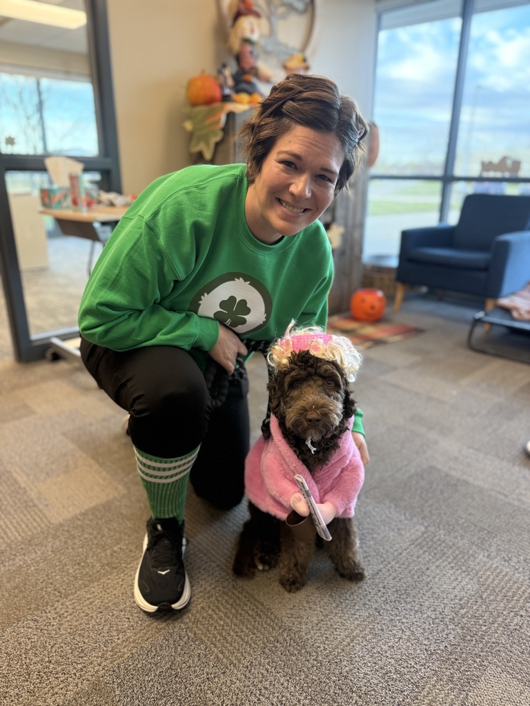 Creekside's Chelsey Hull poses in costume with Frannie the therapy dog