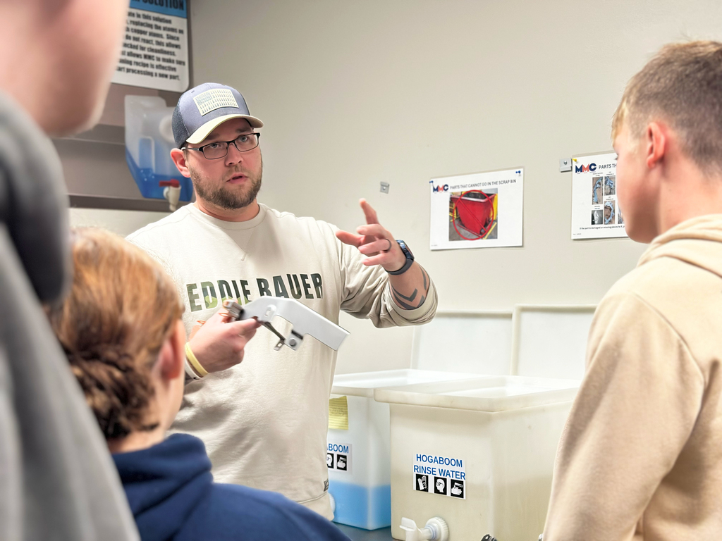 Students at Michigan Metal Coatings see the process of preparing metal parts to be treated 