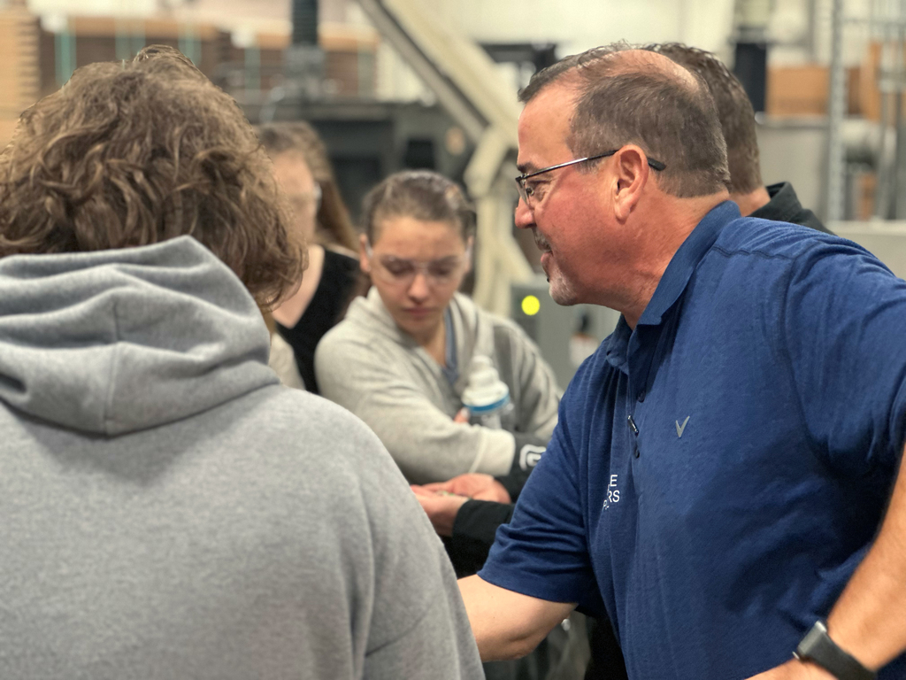 Pier One Polymers Staff show students samples of plastic 