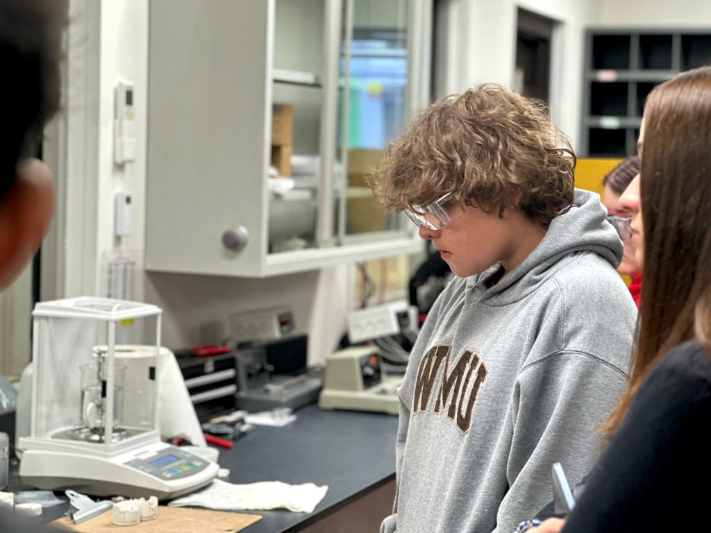 Students at Pier One Polymers get a tour of their plastic testing lab 
