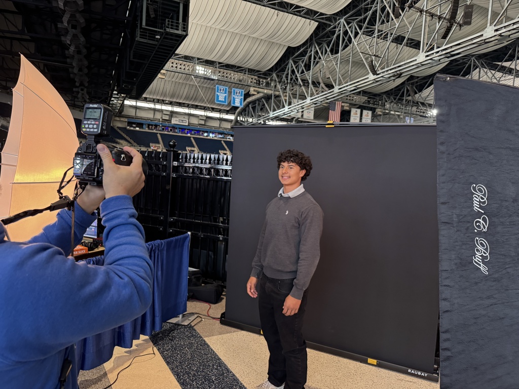 A TEC student smiles while having their photograph taken