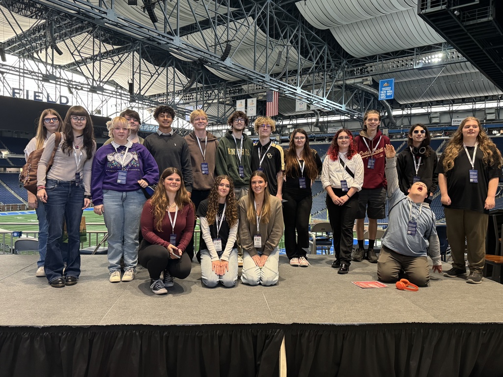 Students in St. Clair TEC's Digital Media Program stand on the stage at Ford Field during the Great Lakes Broadcast and Sports Media Academy