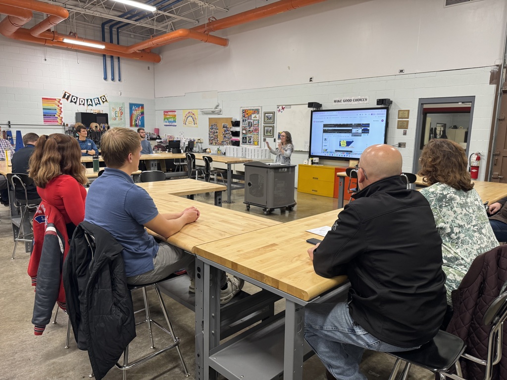 A TEC instructor stands talks to a room of adults