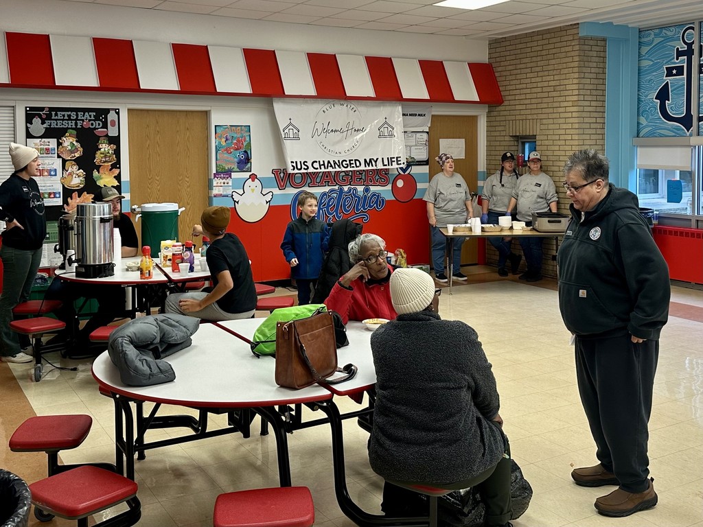 People eating in the cafeteria at Woodrow Wilson Elementary during the Chili and Coats event