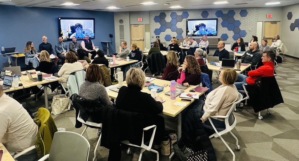 A panel of five IT professionals, seated, talk to a room full of people at the December 3 Counselor Networking Meeting at RESA. 