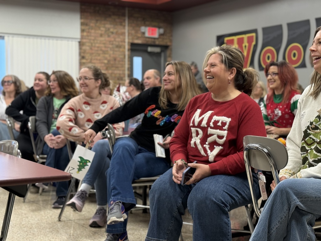 People seated at tables in the Woodland cafeteria during the school's annual Holiday Auction