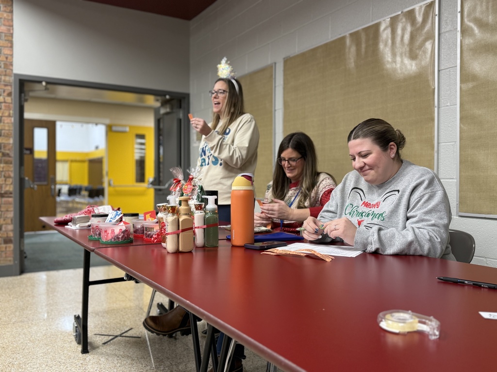 Woodland principal Cora Heyboer wears a holiday headband as she announces a raffle ticket winner