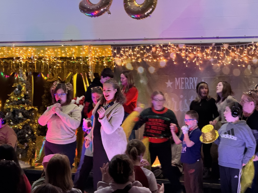 Woodland students dance and sing on stage