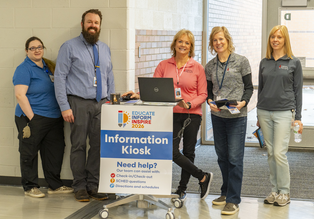 Members of RESA's IT team stand in the hallway at an Information Kiosk