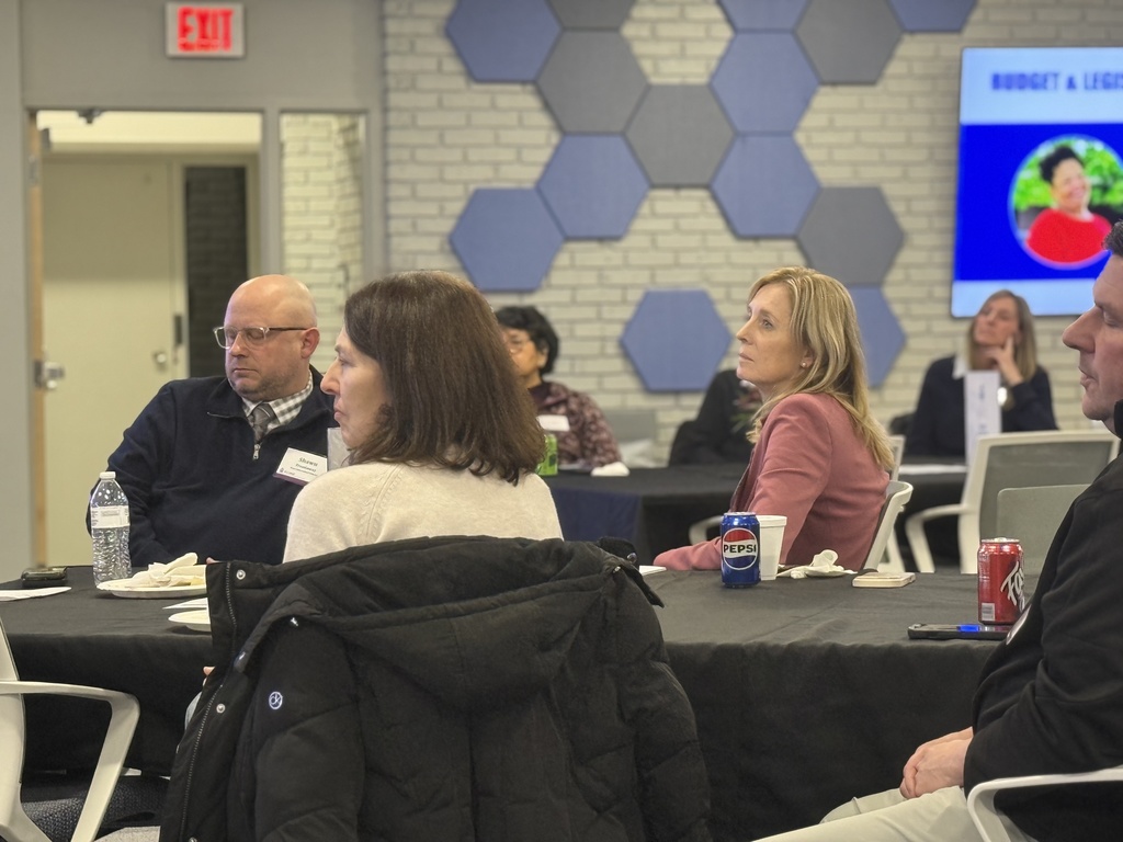 Attendees at the SCCASB annual dinner sit at a table listening to a presentation