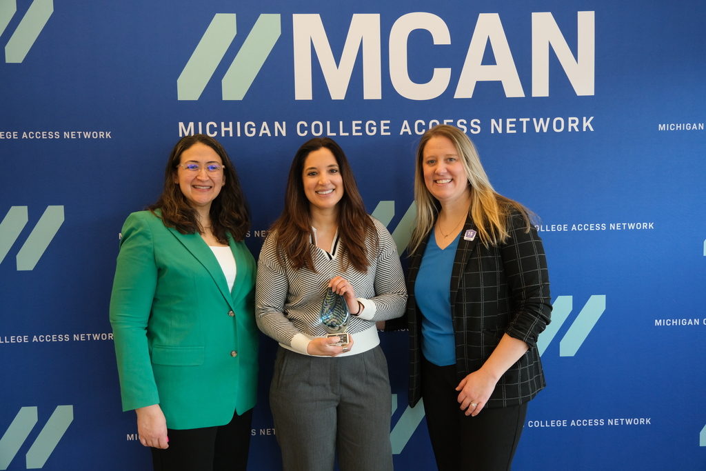 SCCRESA's Lesley Murphy, flanked by two people, holds the award MCAN she received.