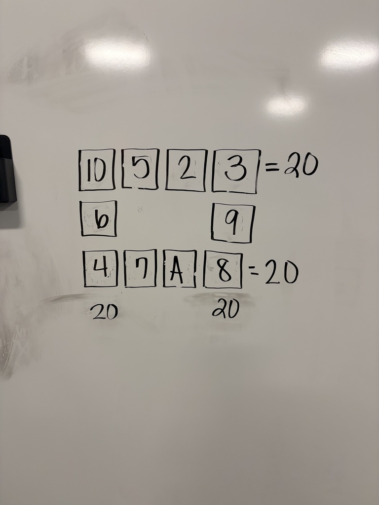 A closeup of a math problem written on a whiteboard