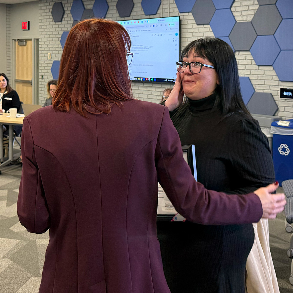 Brenda Tenniswood wraps an arm around a teary Angela Jackson