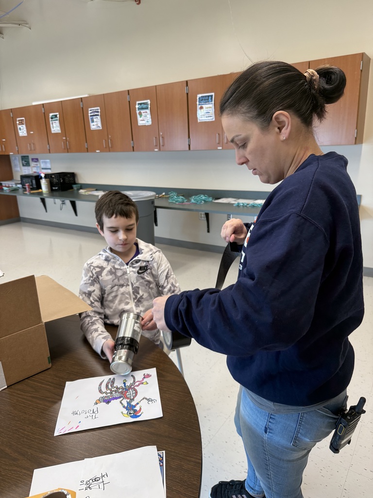 A student and teacher work on a robot