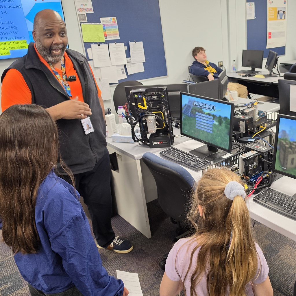 Students listen to a presentation from Cybersecurity program instructor Bobie Jones