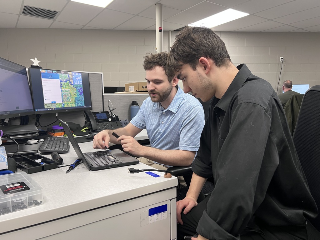 A SCCRESA IT staff member demonstrates laptop troubleshooting and repair techniques to a TEC student