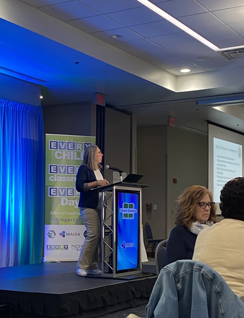 SCCRESA Literacy Coach April Seeley stands at a podium presenting during the MAISA Early Litearcy Network's quarterly meeting.