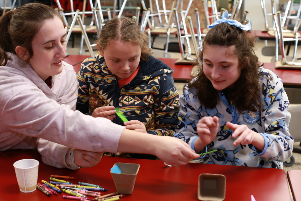 Two students work together to decorate planters during a hands-on Garden Club activity at Woodland Developmental Center.