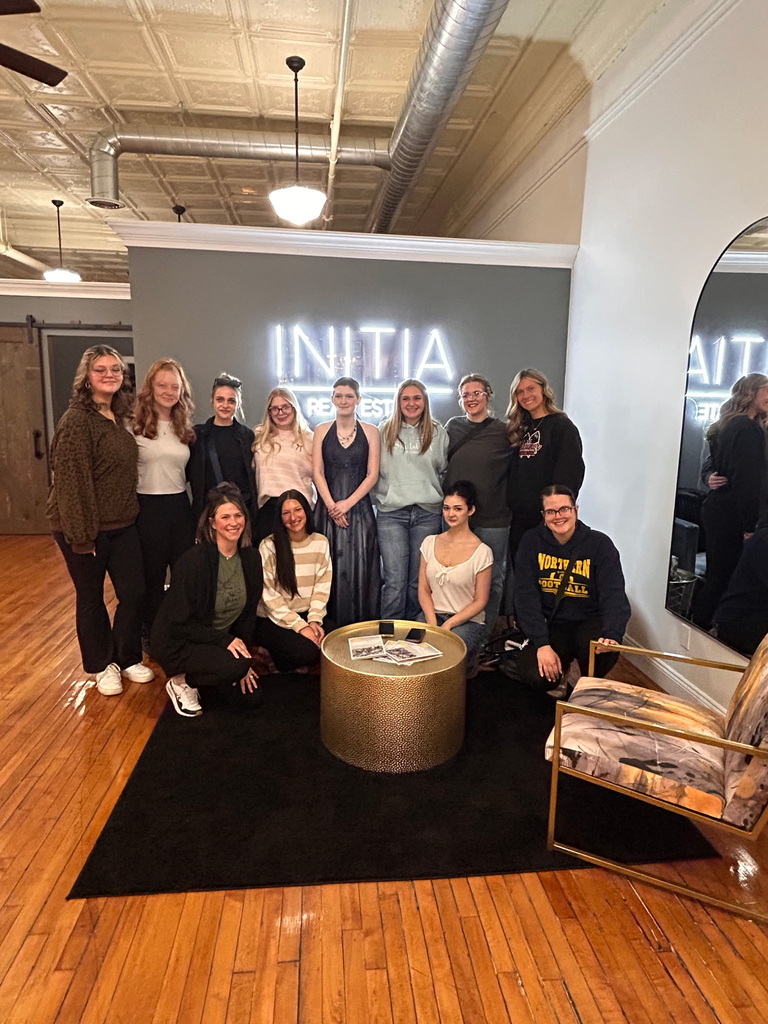 A group of St. Clair TEC Academy of Style students and prom participants pose together inside Initia Real Estate after preparing for prom during the Prom Experience event.