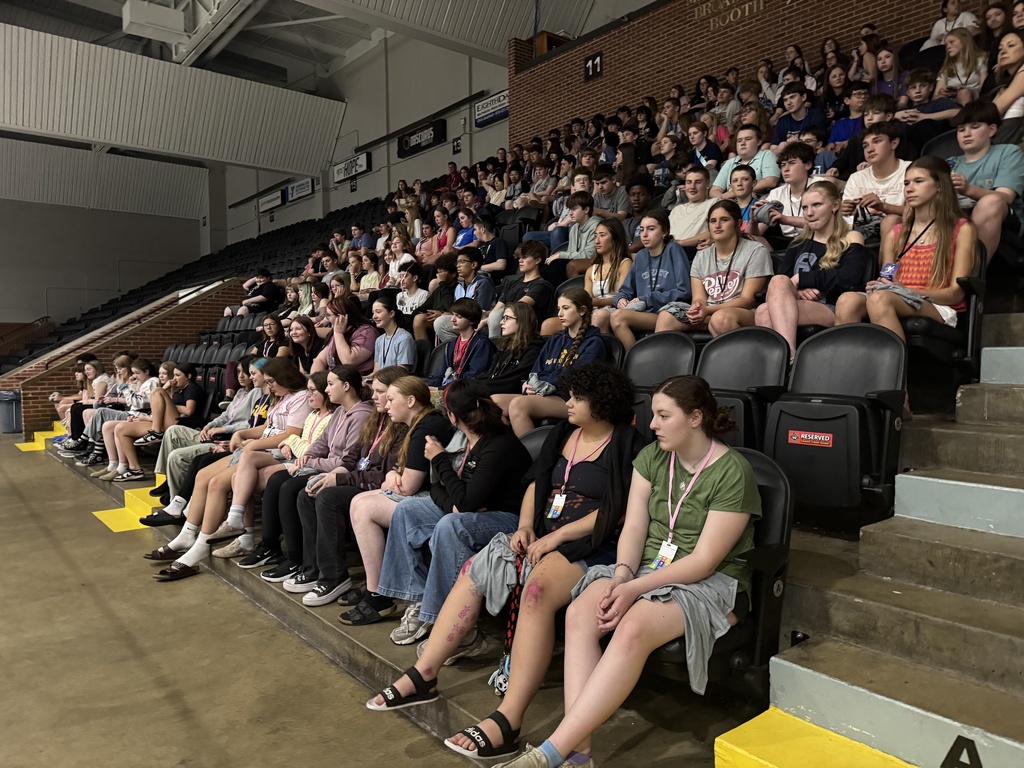 A group of eigth-grade students sit in stadium seating at SC4.