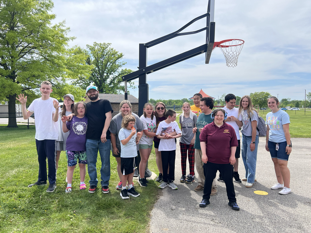 Woodland students and staff pose outside during the after-school sports and games club