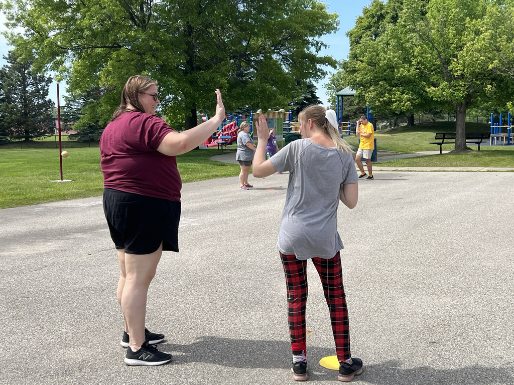 A Woodland staff member high fives a student