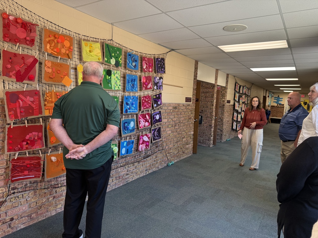 SCCRESA staff and board members view student artwork in the hallway of Woodland Developmental Center