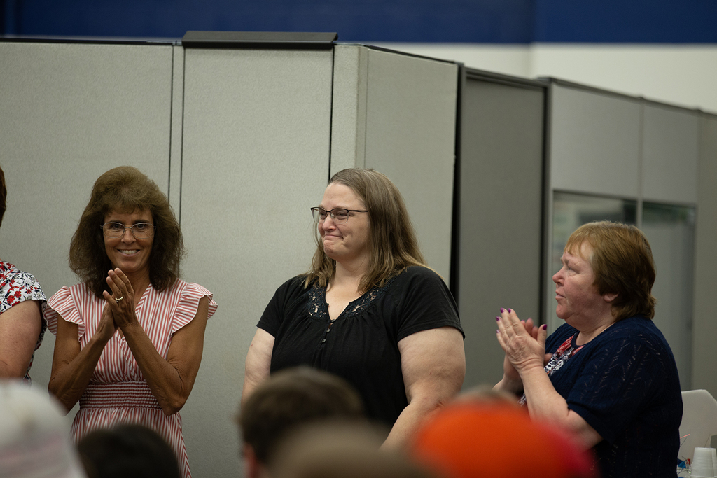 Family members and staff clap during the Next Step completion ceremony