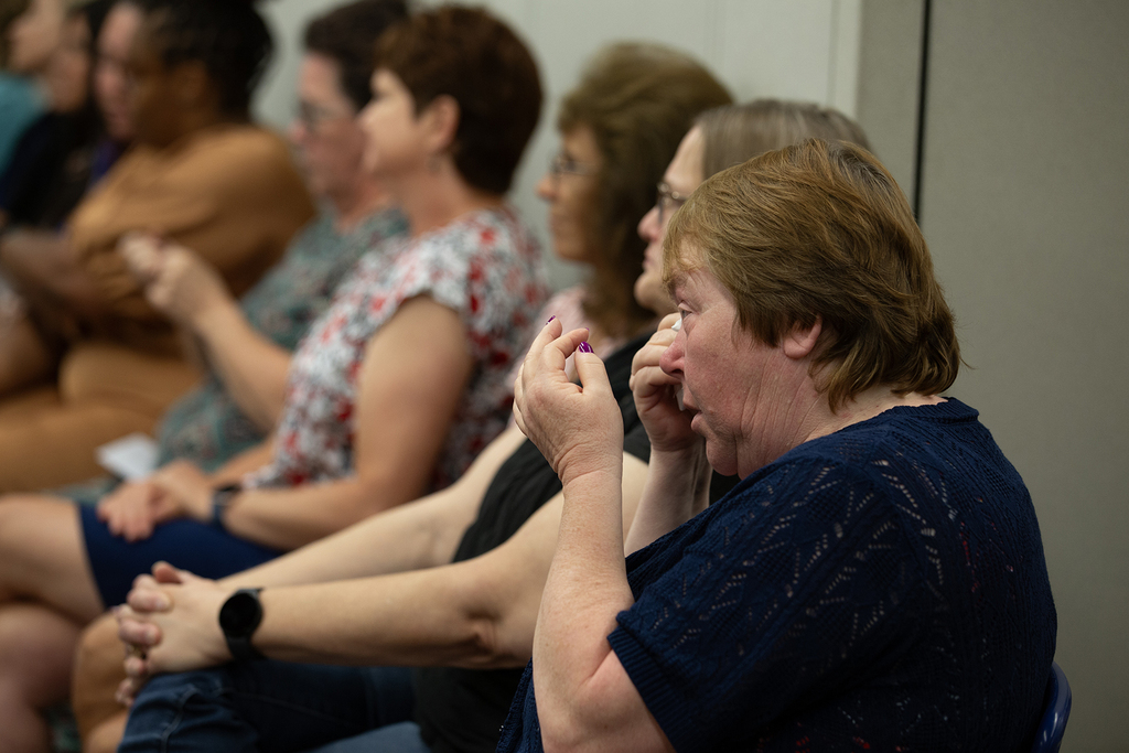 A family member wipes tears from their eyes during the Next Step completion ceremony
