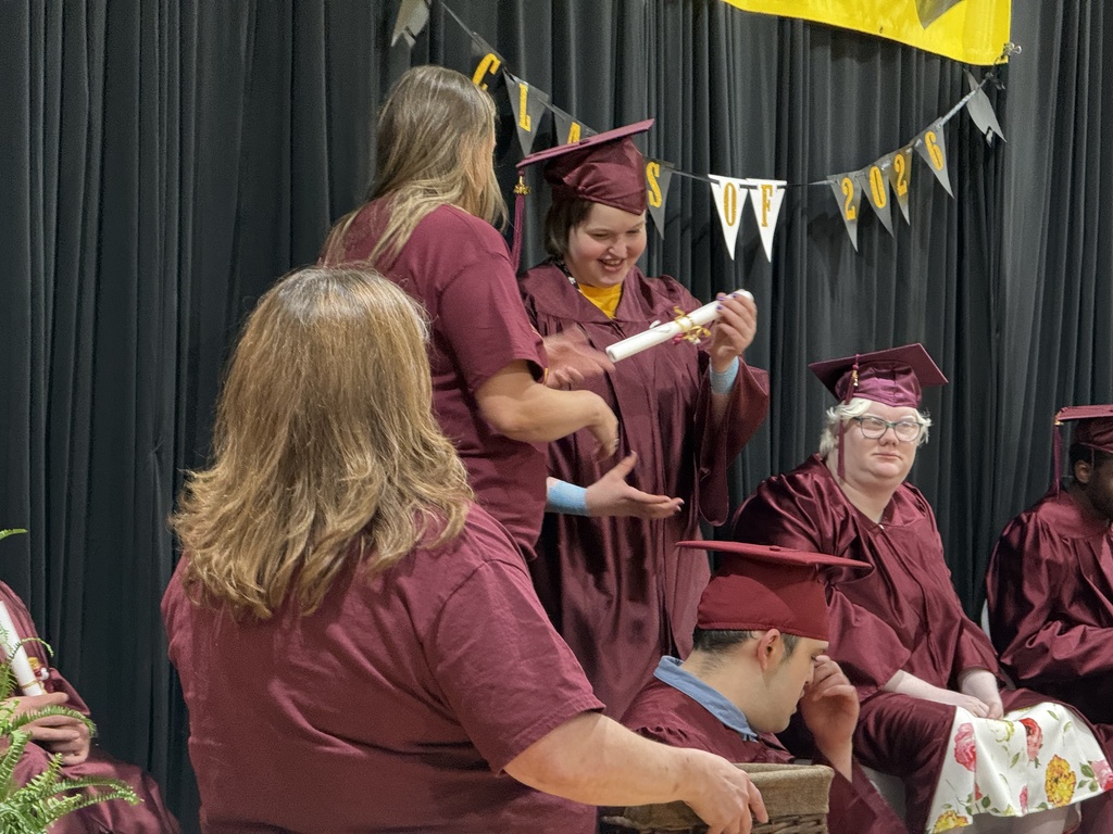 A completer is presented with a certificate during the Completion Ceremony