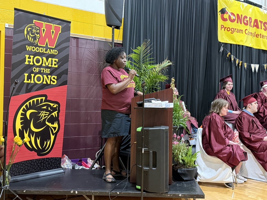 A Woodland staff member delivers a speech as they stand at a lectern