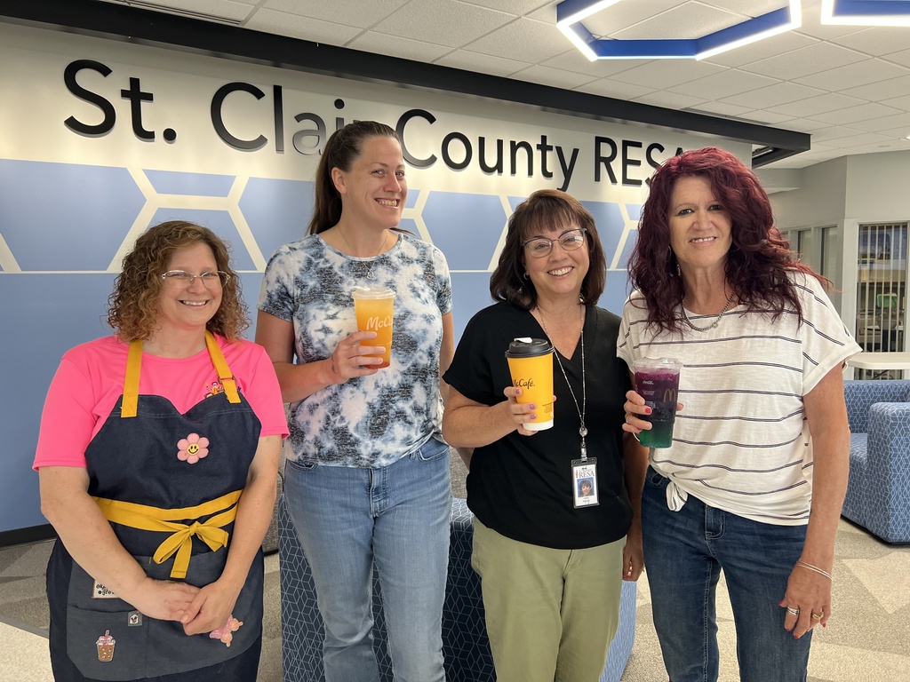 RESA staff hold McDonalds beverages as they pose in the lobby of RESA's Administration Building