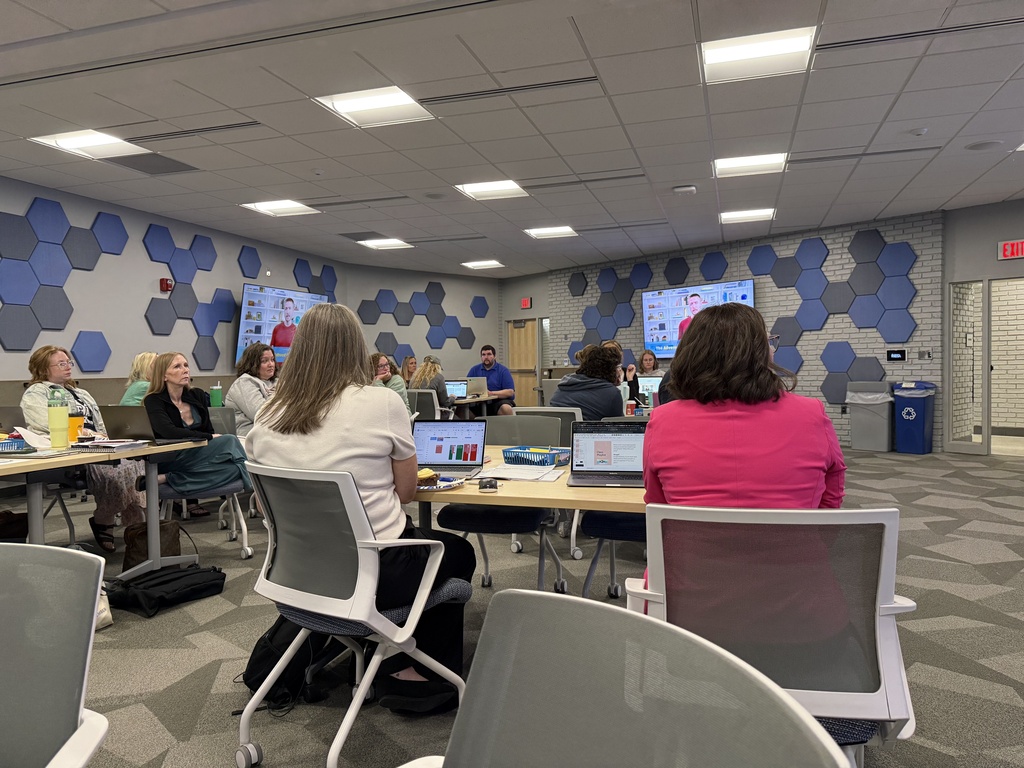 Participants of the Second Shift Academy sit at tables in the RESA's Conference room listening to a presewntation