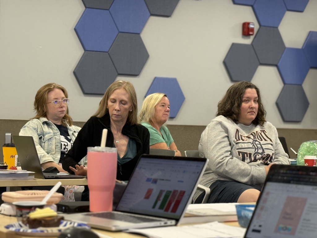 Four educators sit at a table during a presentation as part of the Second Shift Academy