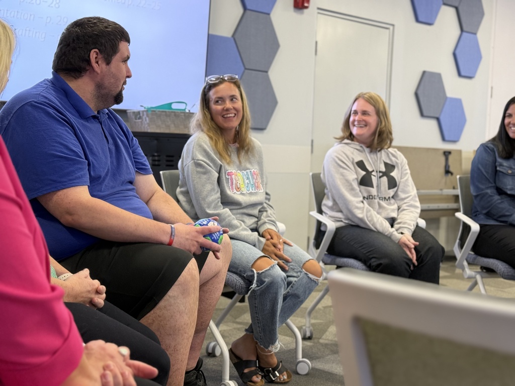 Second Shift participants sit in a circle conversing