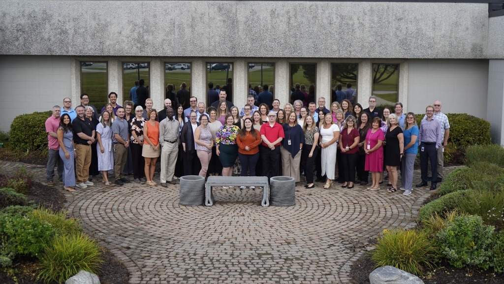St. Clair County TEC staff stand outside in front of the building's entrance.