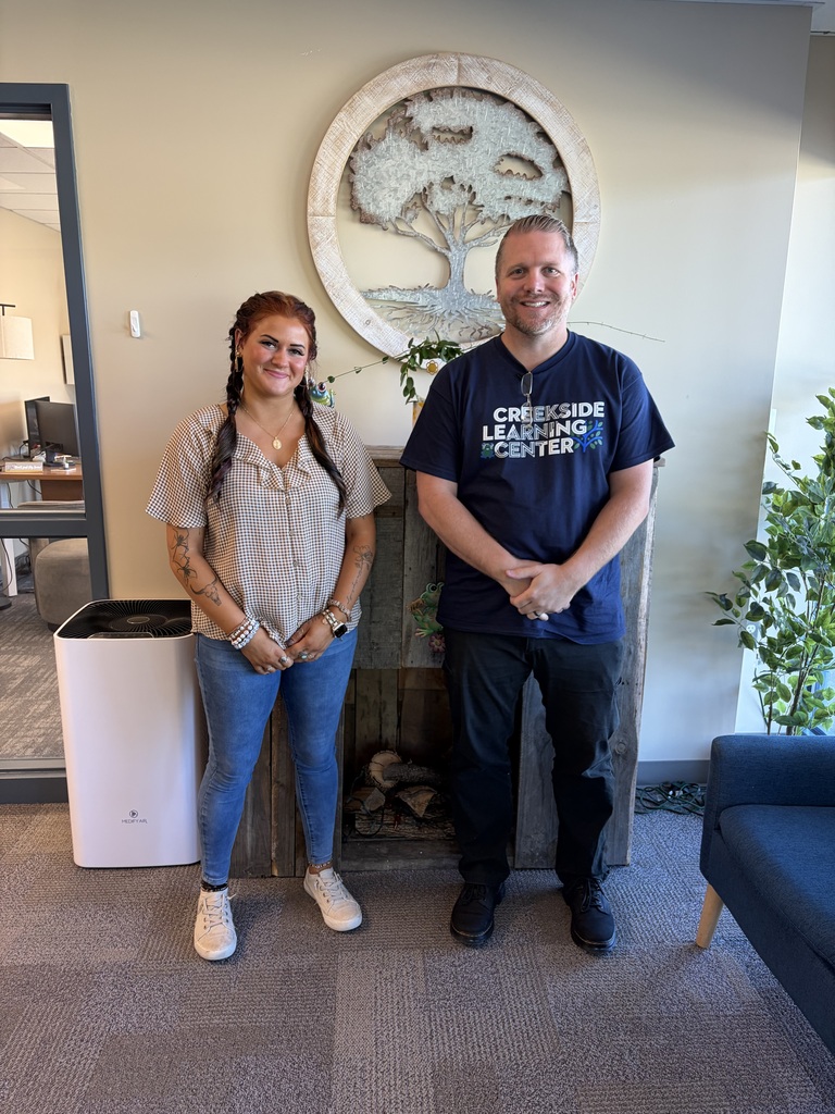 Marissa Hayes and Jason Belfinger pose in the Creekside offices