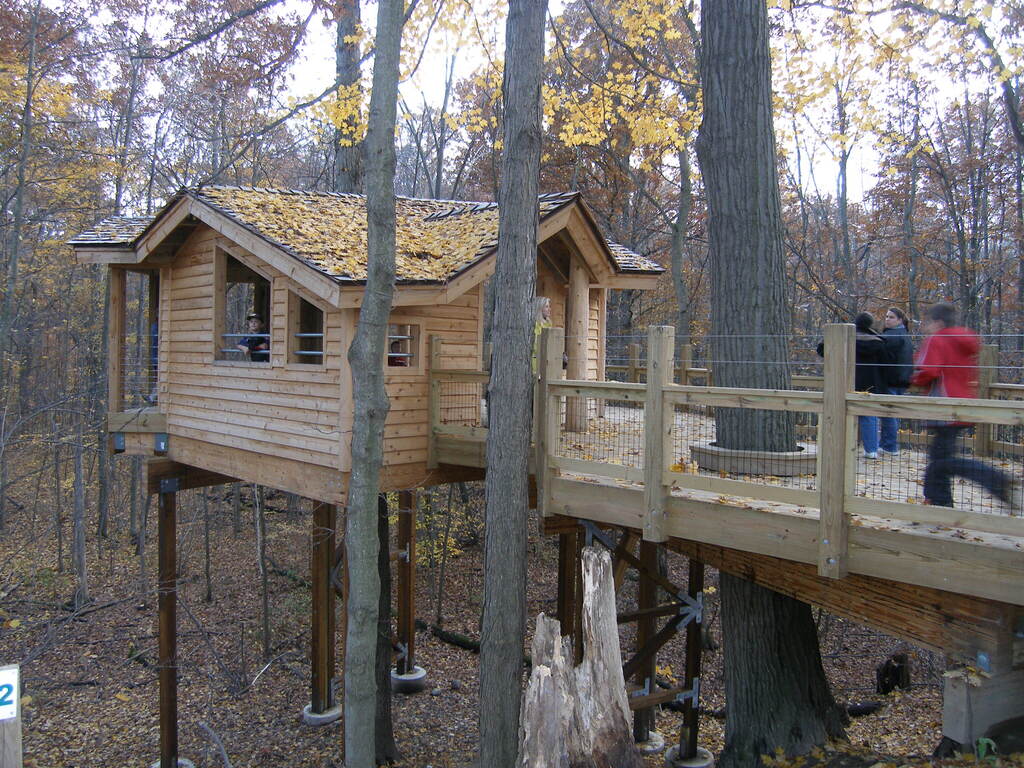 People walk on the ramp to the nature center's universally accessible treehouse