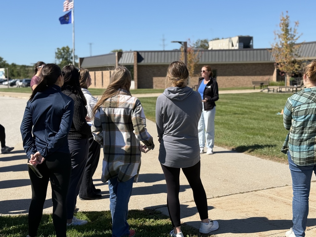 Melissa Kivel talks to 2nd Shift participants outside in front of teh Administration Building on the SCCRESA campus
