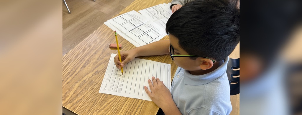 Bellarmine Students at St Edward’s designed and led lessons for our students in grades 2 through 5, this image - Students writing at desks during class.