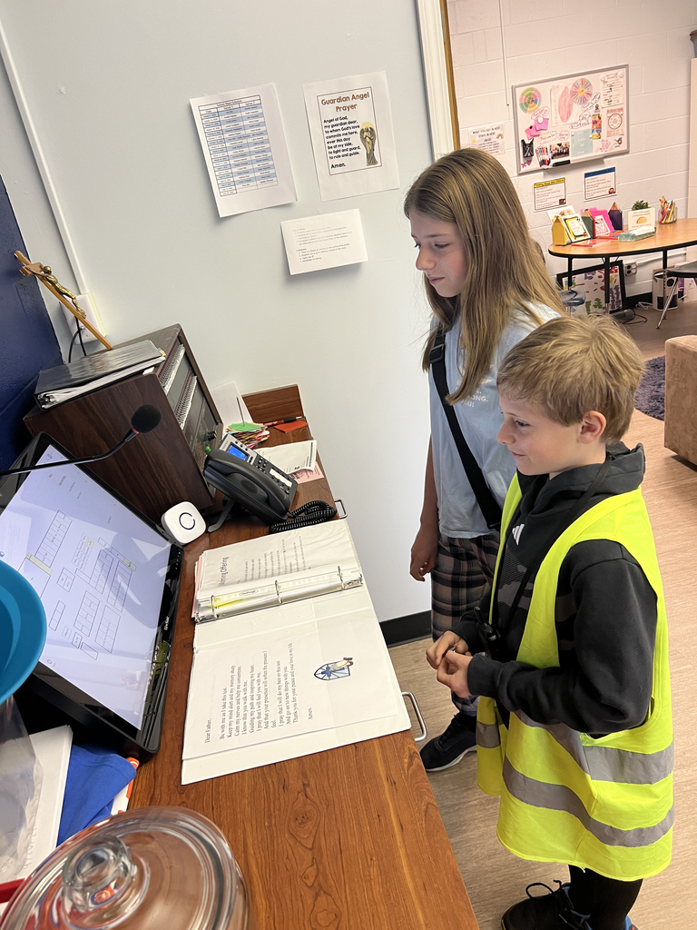 Students reviewing materials for the intercom at the school office
