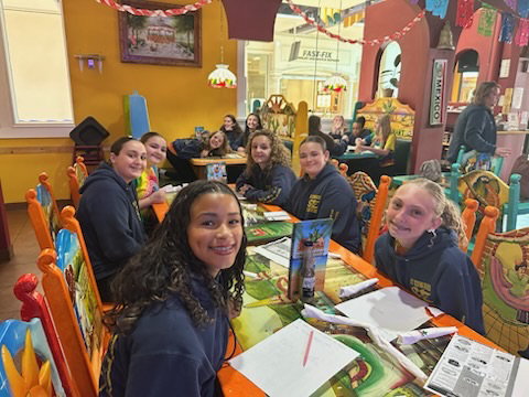 Eighth grade students smiling at El Nopal.