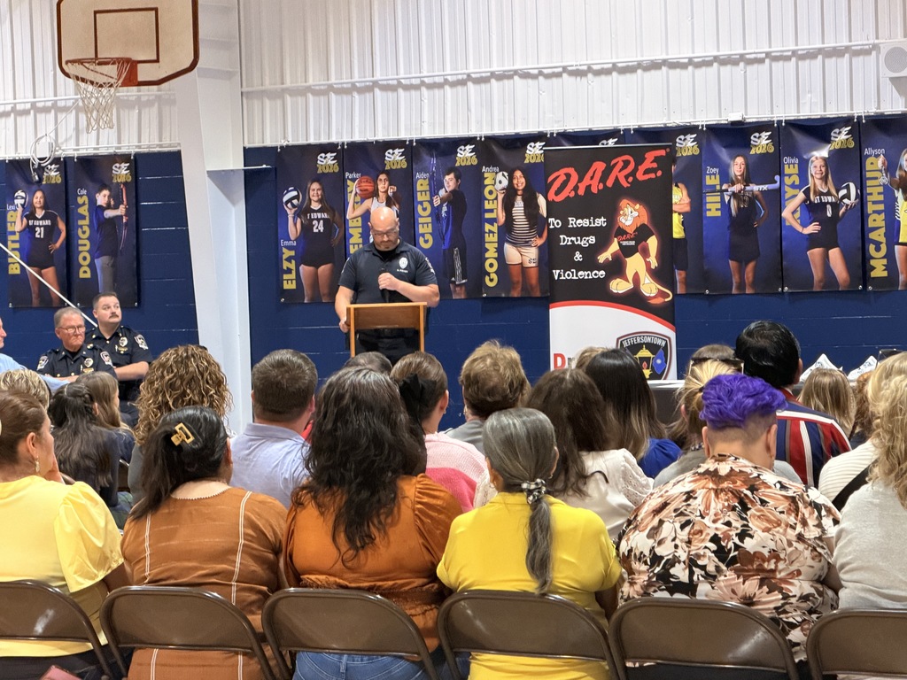 Audience and families watching the D.A.R.E. graduation program.