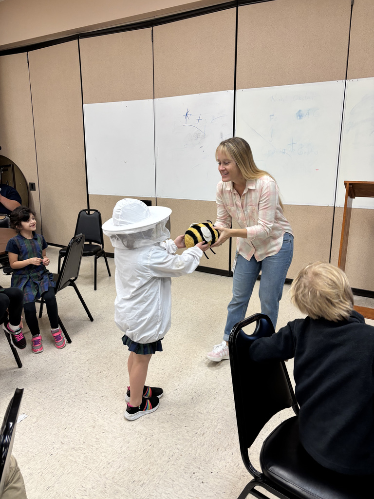 Author Stewart Dunn handing a bee prop to a student.