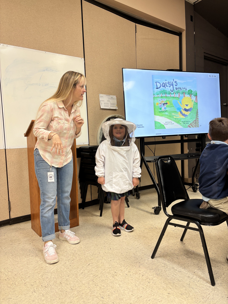 Stewart Dunn presenting with a student in a bee suit.