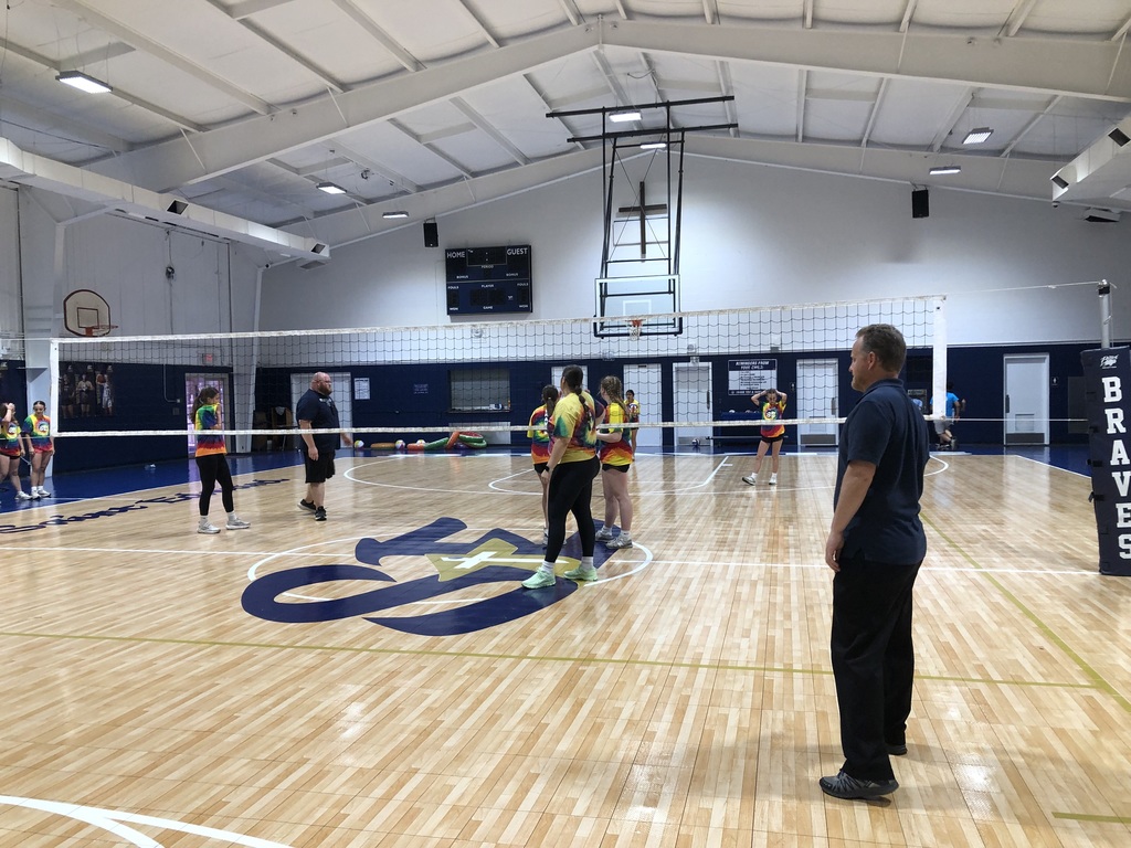 Players lined up on the court during the volleyball game.